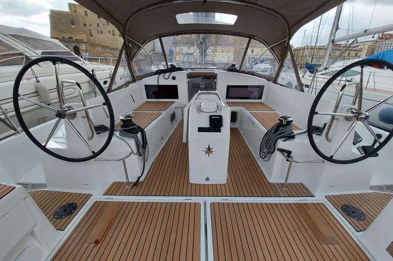 Ssy 01 Yacht Photos Pics 2021 Jeanneau Sun Odyssey 440 yacht cockpit with dual steering wheels and teak flooring.
