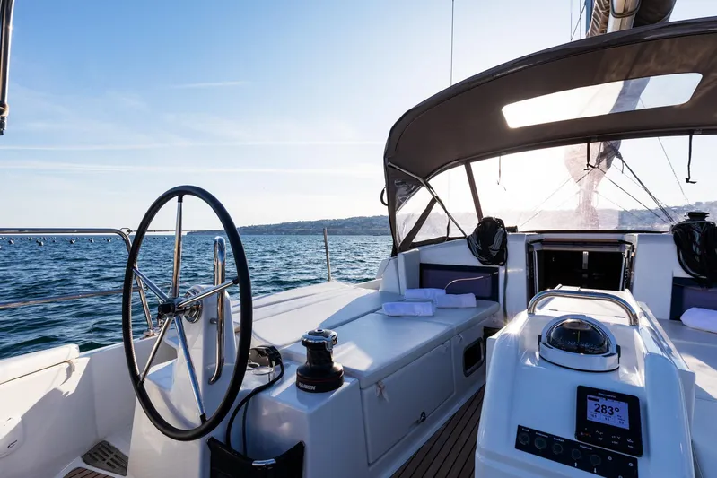 Ssy 01 Yacht Photos Pics Jeanneau Sun Odyssey 440 sailboat cockpit, 2021 model, on open sea with clear skies.