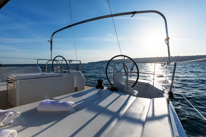 Ssy 01 Yacht Photos Pics 2021 Jeanneau Sun Odyssey 440 sailboat deck with ocean view at sunset.