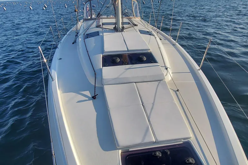Ssy 01 Yacht Photos Pics 2021 Jeanneau Sun Odyssey 440 sailboat on calm water, showcasing sleek deck design.