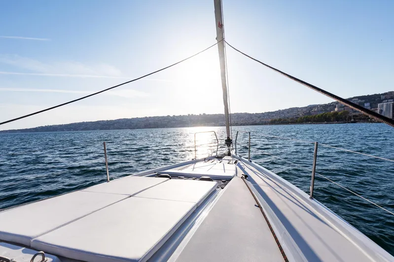 Ssy 01 Yacht Photos Pics Sailing on Jeanneau Sun Odyssey 440, 2021 model, with scenic coastal view.