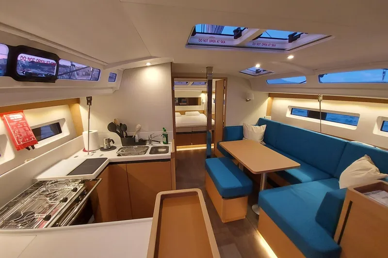 Ssy 01 Yacht Photos Pics Interior of 2021 Jeanneau Sun Odyssey 440 yacht with modern kitchen and seating area.