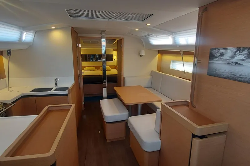 Ssy 01 Yacht Photos Pics Interior of 2021 Jeanneau Sun Odyssey 440 yacht, featuring modern kitchen and cozy seating area.