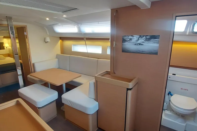 Ssy 01 Yacht Photos Pics Interior of 2021 Jeanneau Sun Odyssey 440 yacht, featuring modern seating and dining area.