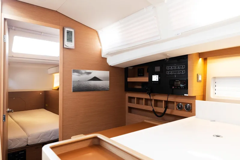 Ssy 01 Yacht Photos Pics Interior of 2021 Jeanneau Sun Odyssey 440 yacht, featuring a cozy cabin and control panel.