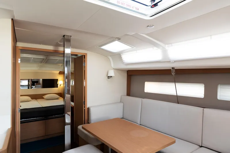 Ssy 01 Yacht Photos Pics Interior of 2021 Jeanneau Sun Odyssey 440 yacht, featuring a cozy seating area and cabin.