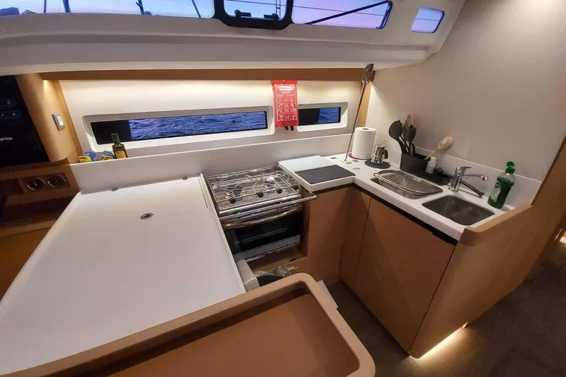 Ssy 01 Yacht Photos Pics Modern kitchen interior of 2021 Jeanneau Sun Odyssey 440 yacht with sleek design and appliances.