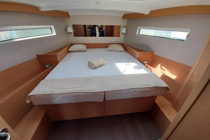 Ssy 01 Yacht Photos Pics Interior cabin of 2021 Jeanneau Sun Odyssey 440 yacht, featuring a cozy bed.