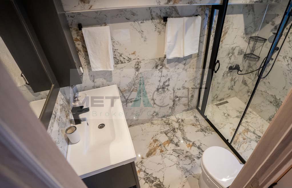 Luxurious bathroom in 2024 Custom Trawler with marble tiles and modern fixtures.