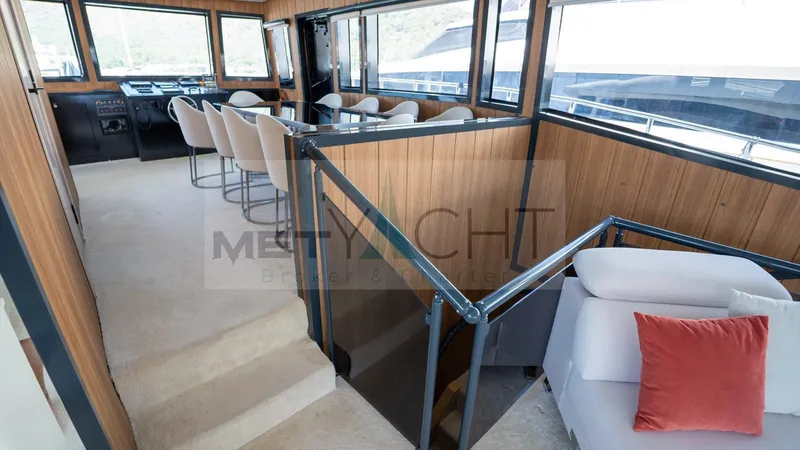  Yacht Photos Pics Luxurious 2024 custom trawler interior with modern seating and panoramic windows.