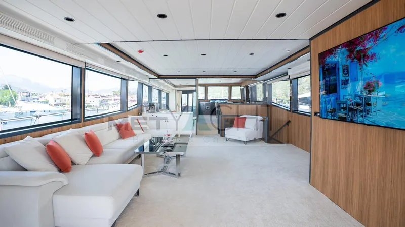  Yacht Photos Pics Luxurious 2024 custom trawler interior with modern decor, large windows, and comfortable seating.