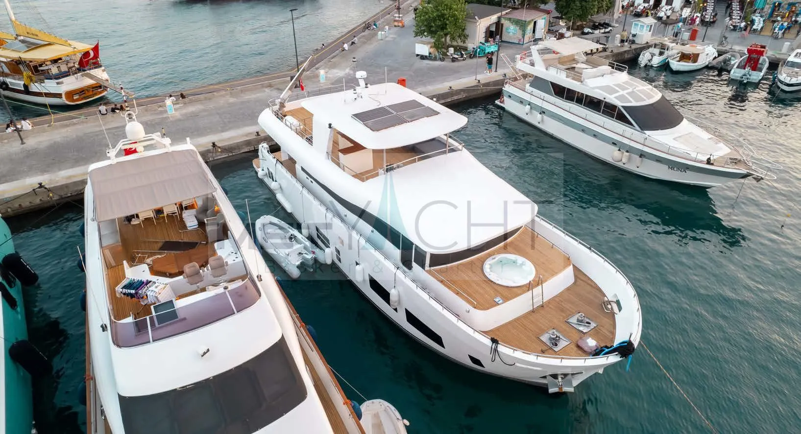 2024 Custom Trawler yacht docked at a marina, featuring a spacious deck and modern design.