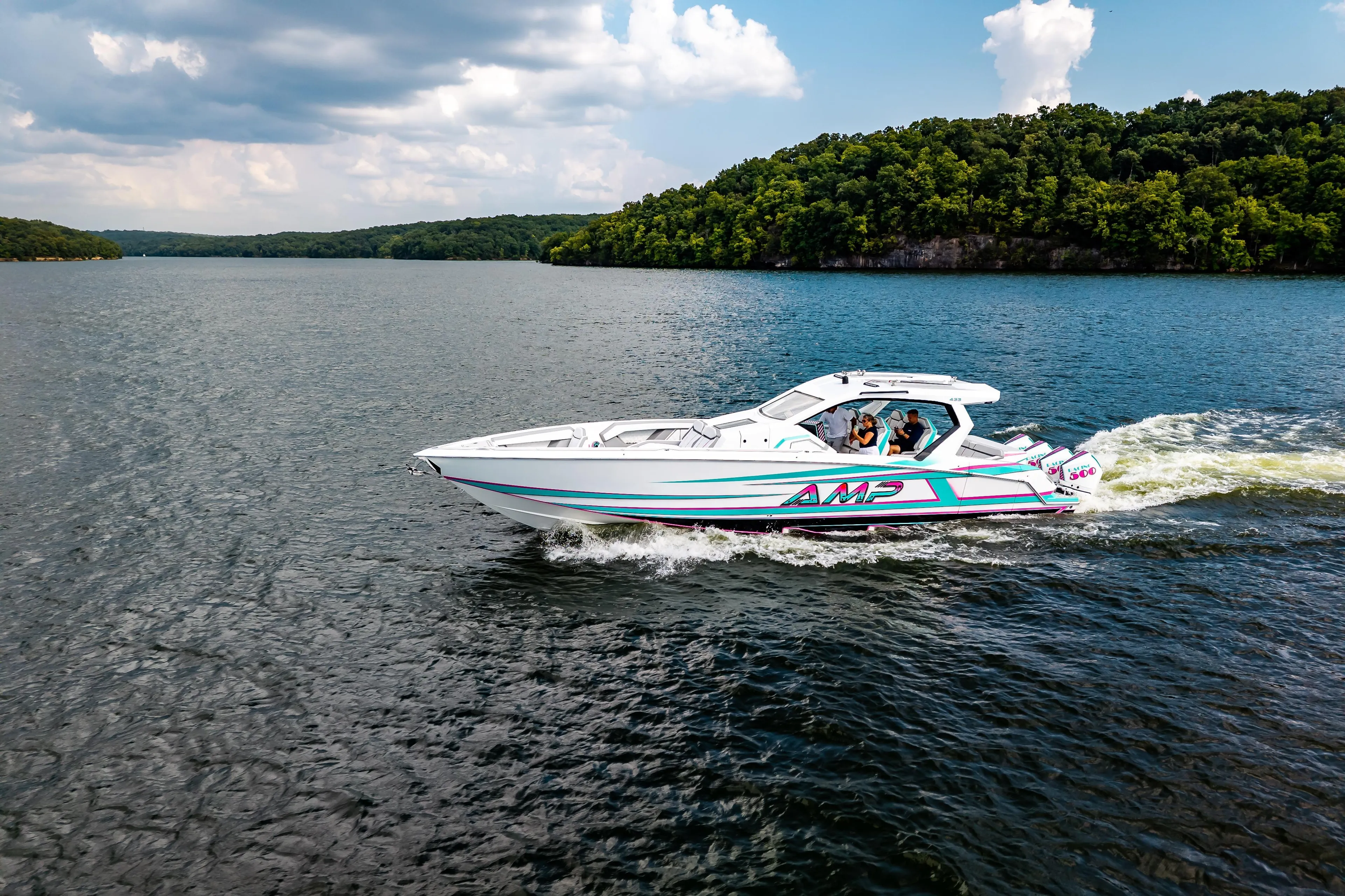 High-performance AMP 443 speedboat cruising on a scenic lake, 2025 model.