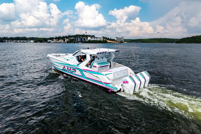  Yacht Photos Pics 2025 AMP 443 boat cruising on a lake under a partly cloudy sky.