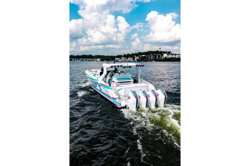  Yacht Photos Pics Futuristic AMP 443 boat cruising on a lake under a cloudy sky, 2025 model.