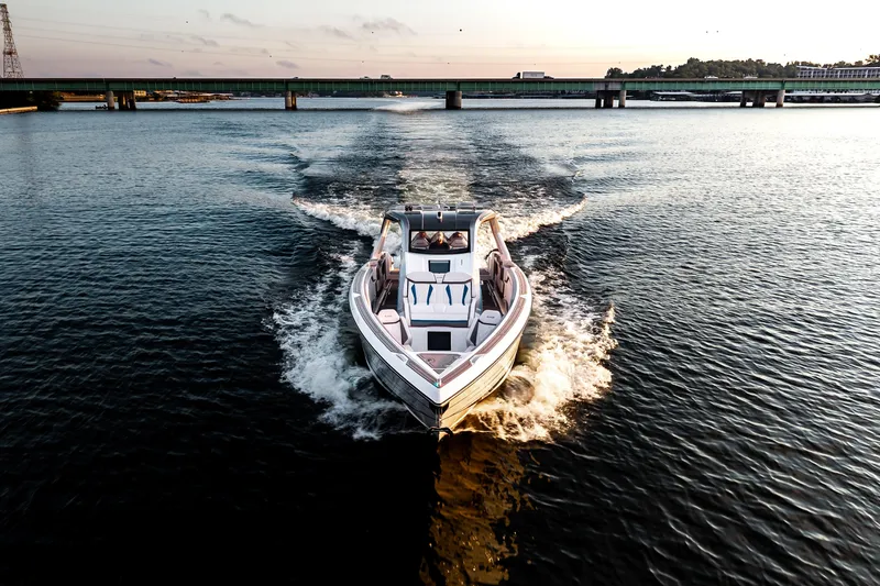  Yacht Photos Pics Modern AMP 443 boat cruising on a serene river at sunset, 2025 model.