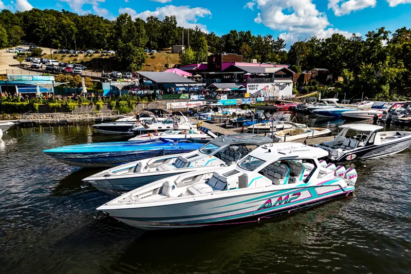  Yacht Photos Pics Boats docked at a lively marina, featuring a 2025 AMP 443 model under a sunny sky.