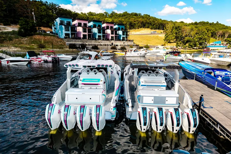  Yacht Photos Pics Boats docked at a marina with colorful buildings in the background, featuring AMP 443 model.