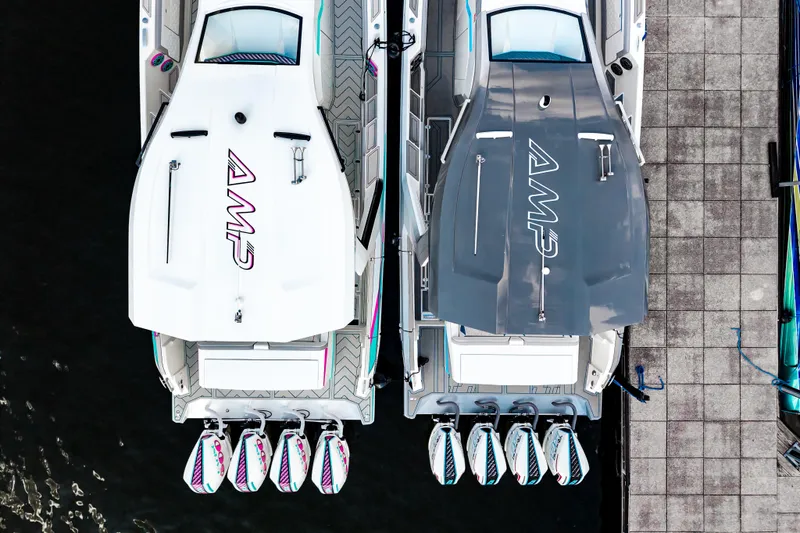 Yacht Photos Pics Overhead view of two AMP 443 boats docked, showcasing sleek design and multiple engines.