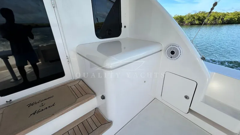 Sin Plan Yacht Photos Pics 2005 Bertram 630E yacht deck with steps, storage, and water view.