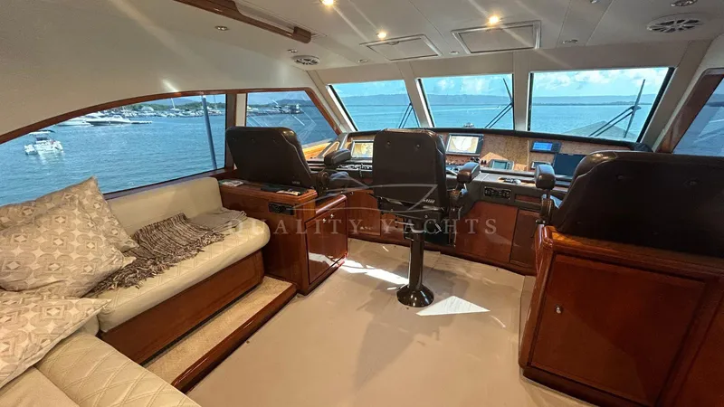 Sin Plan Yacht Photos Pics Interior of 2005 Bertram 630E yacht with helm station and seating area.