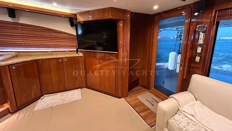 Sin Plan Yacht Photos Pics Interior of 2005 Bertram 630E yacht with wooden cabinetry and ocean view.