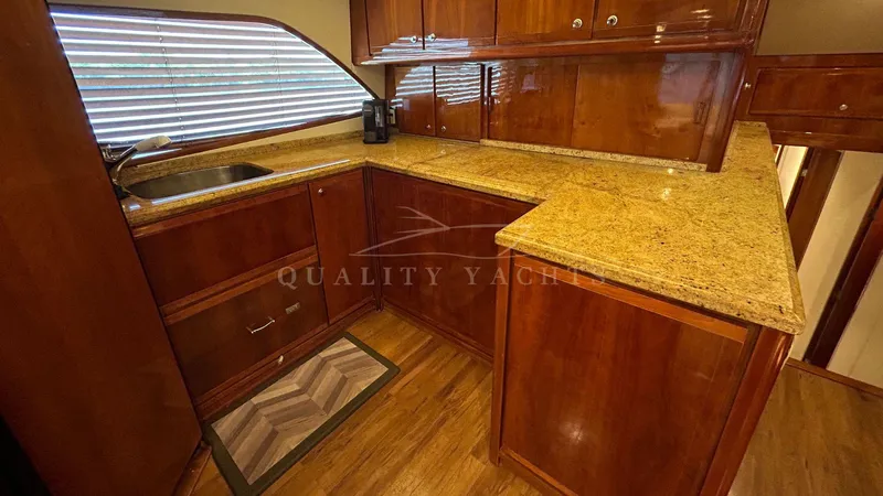 Sin Plan Yacht Photos Pics Luxurious kitchen area in a 2005 Bertram 630E yacht with granite countertops.