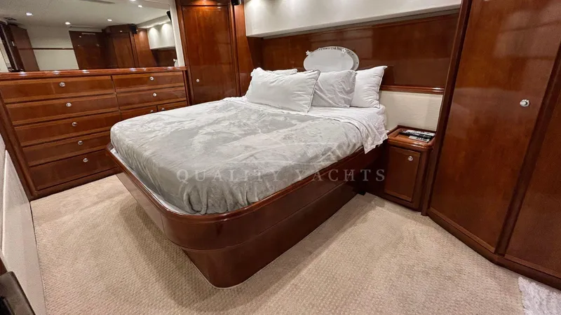 Sin Plan Yacht Photos Pics Luxurious master bedroom on a 2005 Bertram 630E yacht with elegant wood finishes.