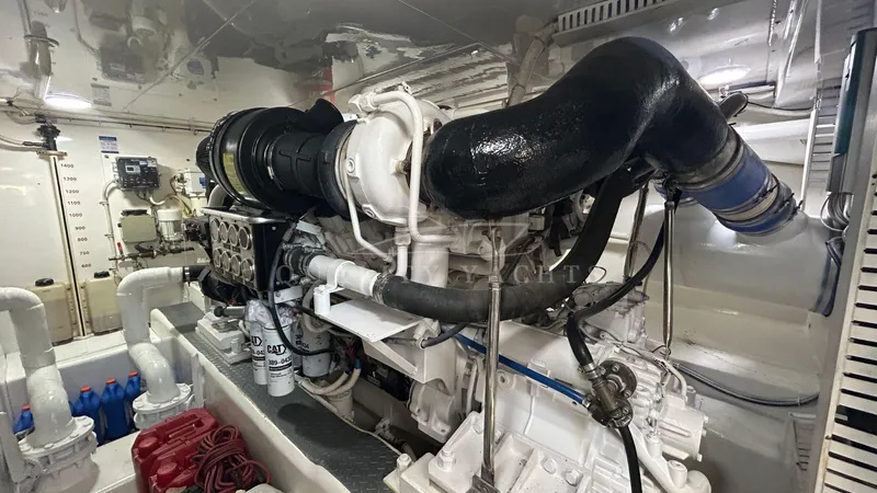 Sin Plan Yacht Photos Pics Engine room of a 2005 Bertram 630E yacht with visible machinery.