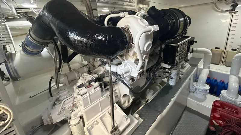 Sin Plan Yacht Photos Pics Engine room of a 2005 Bertram 630E yacht showing detailed machinery.