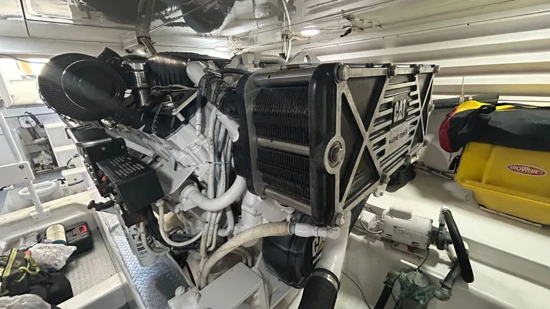 Sin Plan Yacht Photos Pics Engine room of a 2005 Bertram 630E yacht with visible machinery.