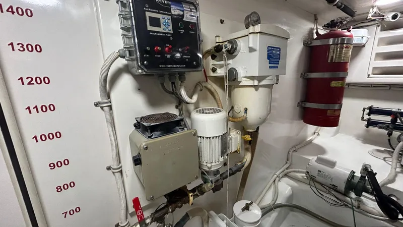 Sin Plan Yacht Photos Pics Engine room of a 2005 Bertram 630E yacht with various equipment and gauges.