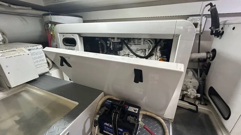 Sin Plan Yacht Photos Pics Engine compartment of a 2005 Bertram 630E yacht with open access panel.