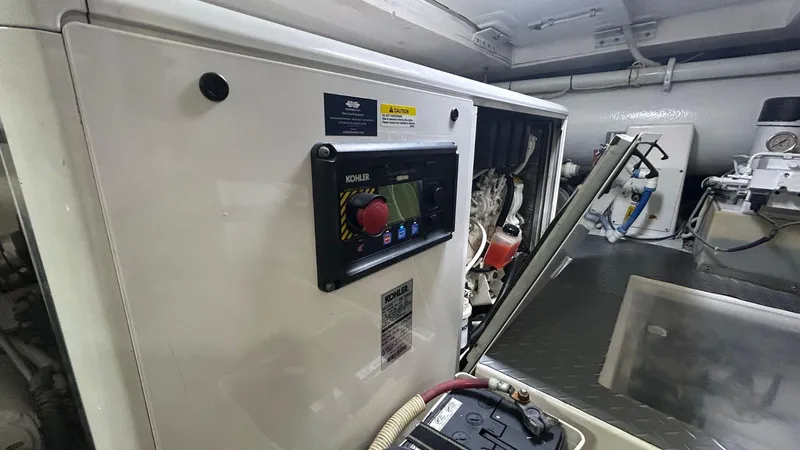 Sin Plan Yacht Photos Pics Engine room of a 2005 Bertram 630E yacht with control panel.