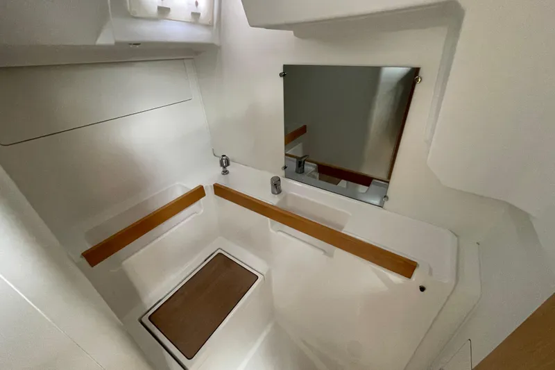 Moonshadow Yacht Photos Pics 2016 Beneteau Oceanis 38 bathroom interior with mirror and wooden accents.