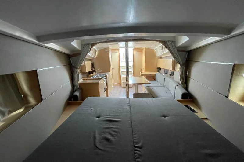 Moonshadow Yacht Photos Pics Interior of 2016 Beneteau Oceanis 38 yacht, featuring modern kitchen and cozy seating area.