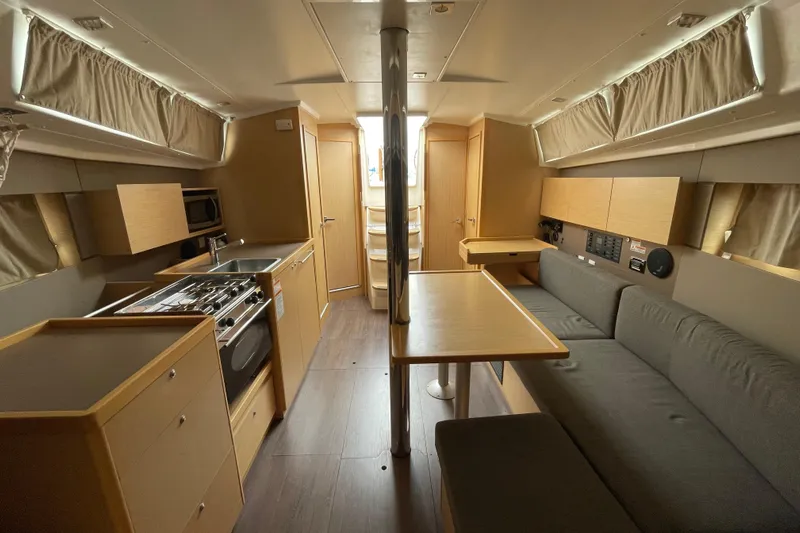 Moonshadow Yacht Photos Pics Interior of 2016 Beneteau Oceanis 38 yacht with modern kitchen and seating area.