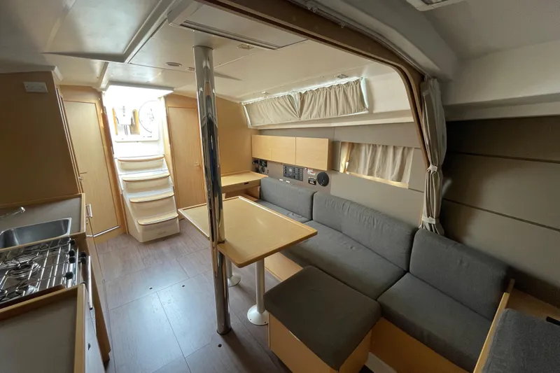 Moonshadow Yacht Photos Pics Interior of 2016 Beneteau Oceanis 38 yacht, featuring modern kitchen and cozy seating area.