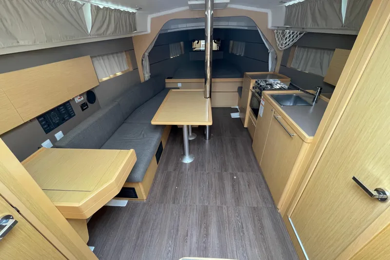 Moonshadow Yacht Photos Pics Interior of 2016 Beneteau Oceanis 38 sailboat with modern kitchen and seating area.