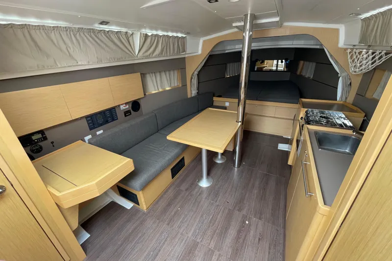 Moonshadow Yacht Photos Pics Interior of 2016 Beneteau Oceanis 38 sailboat with modern kitchen and seating area.