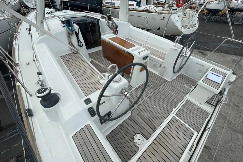 Moonshadow Yacht Photos Pics 2016 Beneteau Oceanis 38 sailboat cockpit with dual steering wheels and teak decking.