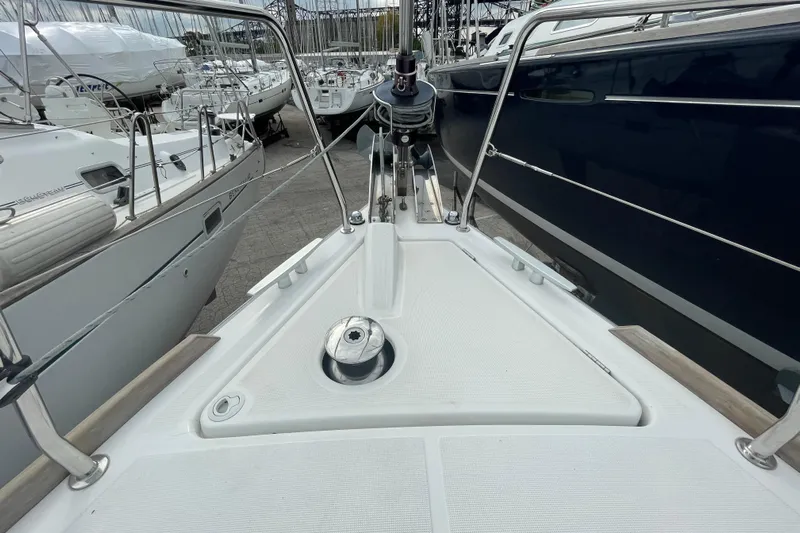 Moonshadow Yacht Photos Pics Bow view of 2016 Beneteau Oceanis 38 sailboat in marina setting.