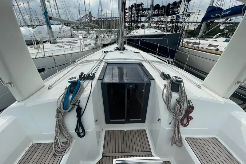 Moonshadow Yacht Photos Pics 2016 Beneteau Oceanis 38 sailboat deck with ropes and winches in marina setting.