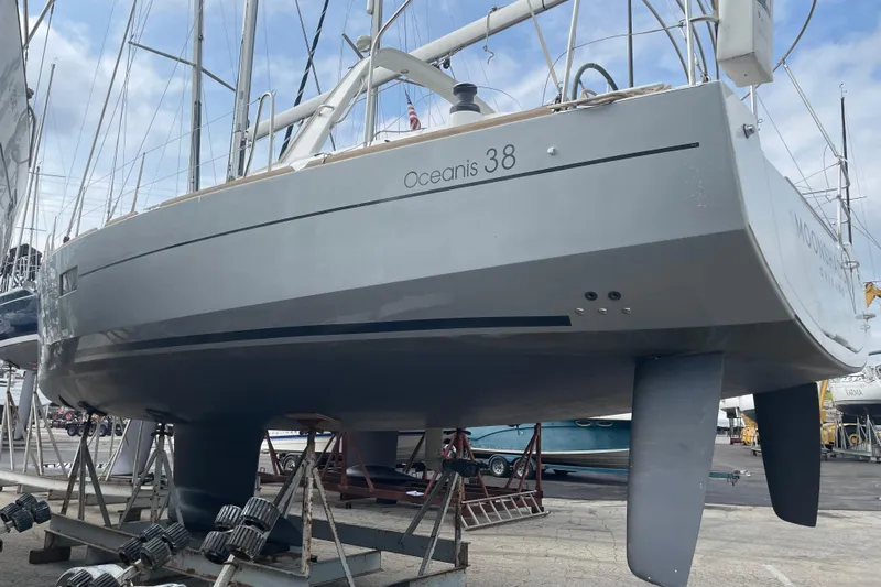 Moonshadow Yacht Photos Pics 2016 Beneteau Oceanis 38 sailboat on dry dock, showcasing sleek hull design.