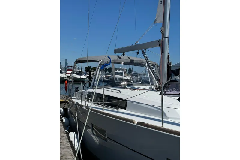 Moonshadow Yacht Photos Pics 2016 Beneteau Oceanis 38 sailboat docked at marina under clear blue sky.