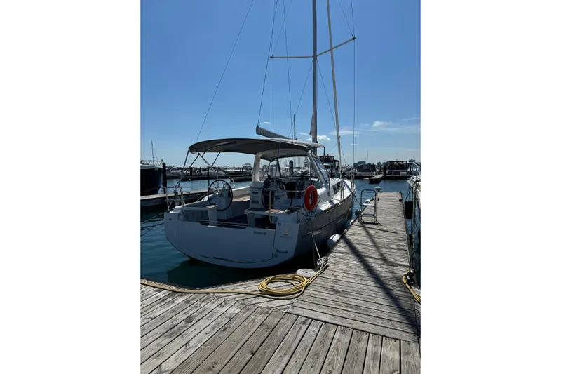 Moonshadow Yacht Photos Pics 2016 Beneteau Oceanis 38 sailboat docked at marina under clear blue sky.