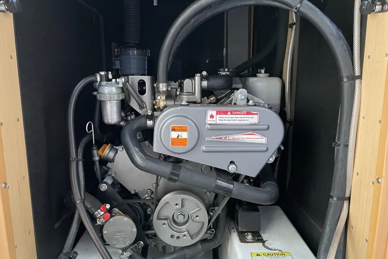 Moonshadow Yacht Photos Pics Engine compartment of a 2016 Beneteau Oceanis 38 sailboat, showcasing mechanical components.