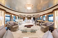 Luxurious interior of 2001 Oceanco Custom yacht with elegant seating and grand piano.