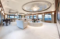 Luxurious yacht interior with elegant seating, chandelier, and panoramic windows, Oceanco Custom 2001 model.