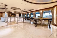 Luxurious yacht interior with elegant dining area, marble flooring, and panoramic windows, Oceanco Custom 2001.